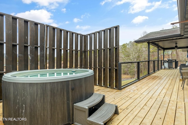 wooden terrace with ceiling fan, grilling area, a hot tub, and central AC unit