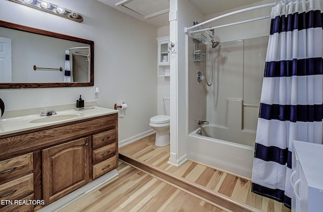 full bathroom featuring wood-type flooring, vanity, shower / tub combo with curtain, and toilet