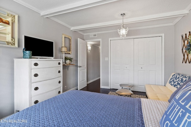 bedroom featuring crown molding, dark wood-type flooring, a closet, and beamed ceiling