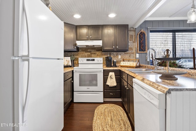 kitchen with sink, white appliances, dark wood-type flooring, ornamental molding, and decorative backsplash