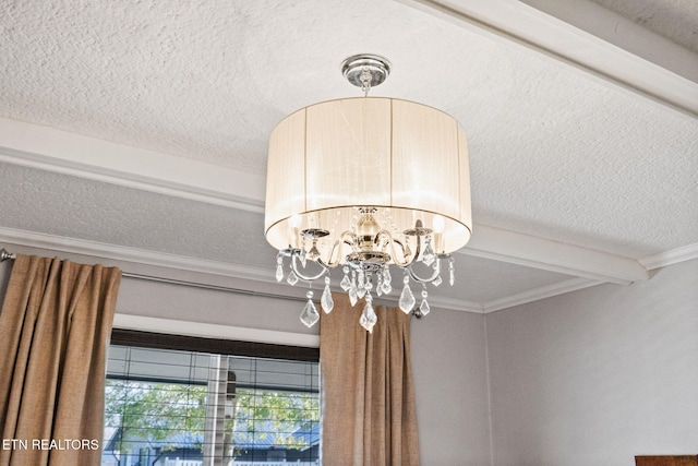 details featuring a notable chandelier, beam ceiling, ornamental molding, and a textured ceiling