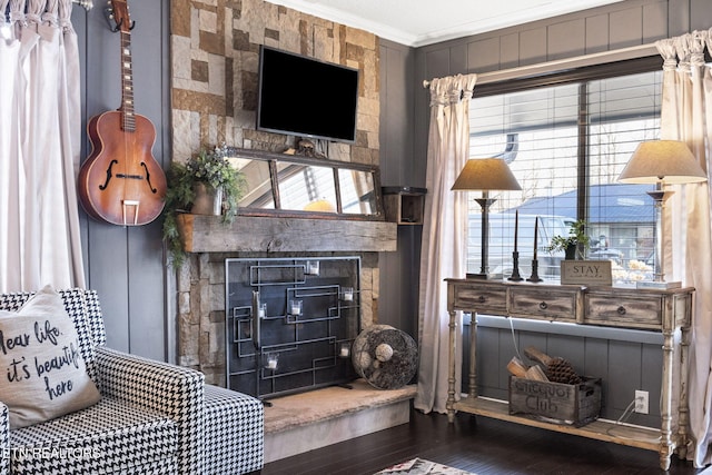 living room featuring ornamental molding and wood-type flooring