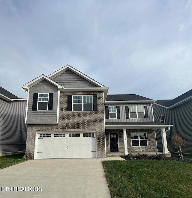 view of front of property with a garage and a front lawn