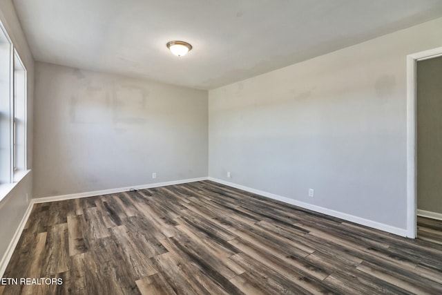 spare room with dark hardwood / wood-style floors