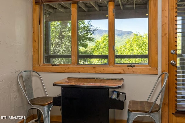 sunroom / solarium featuring a mountain view