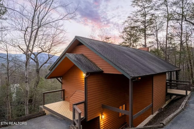 property exterior at dusk with a mountain view