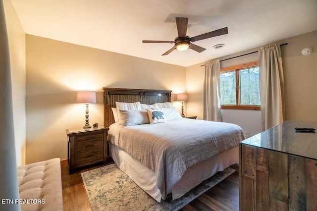 bedroom featuring ceiling fan and dark hardwood / wood-style flooring