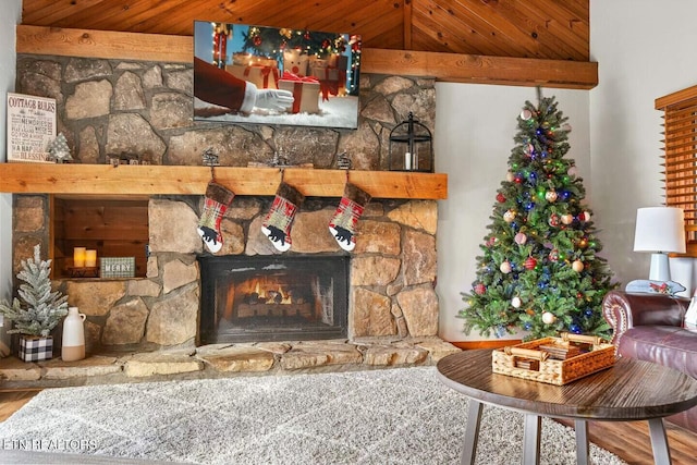 living room with a stone fireplace and hardwood / wood-style flooring