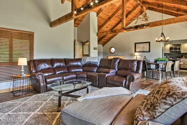 living room featuring beam ceiling, a notable chandelier, hardwood / wood-style flooring, and high vaulted ceiling