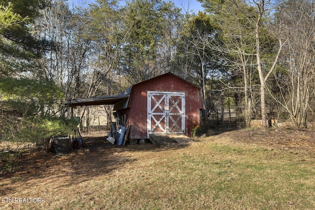 view of outbuilding with a lawn