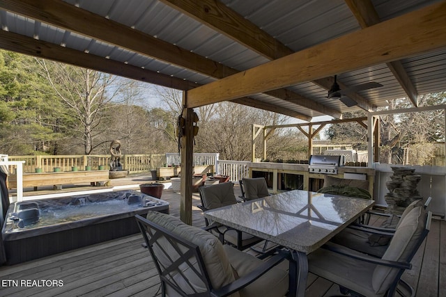 wooden terrace featuring an outdoor hot tub, grilling area, ceiling fan, and an outdoor kitchen