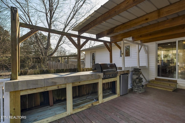 wooden deck featuring a grill