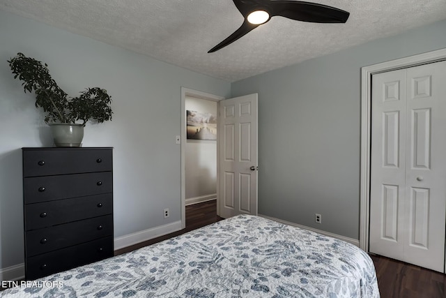 bedroom featuring dark hardwood / wood-style flooring, ceiling fan, a closet, and a textured ceiling