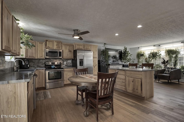 kitchen featuring sink, decorative backsplash, stainless steel appliances, and light hardwood / wood-style floors