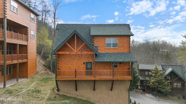 back of house featuring a balcony