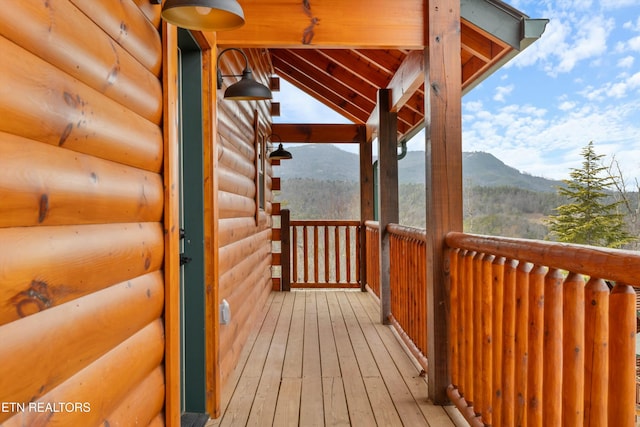 wooden deck featuring a mountain view