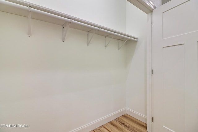 spacious closet featuring light hardwood / wood-style floors