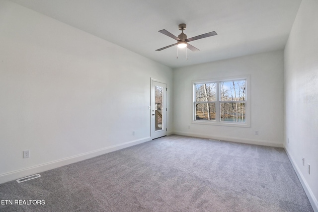 empty room featuring ceiling fan and carpet floors