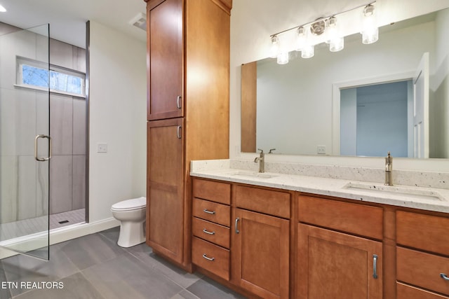 bathroom featuring vanity, an enclosed shower, and toilet