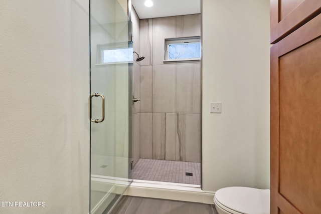 bathroom featuring toilet and walk in shower