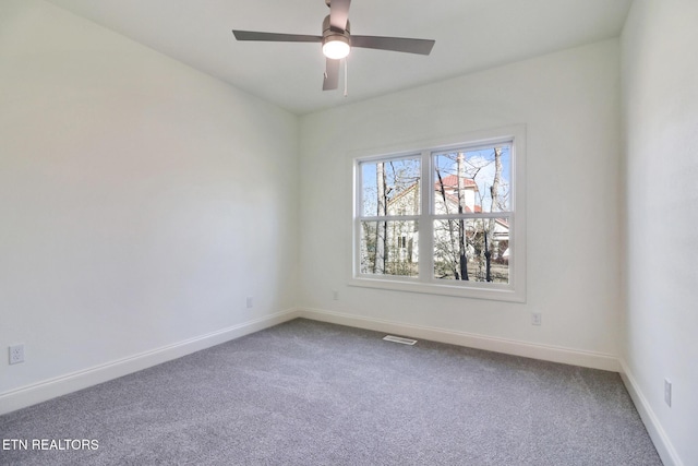 carpeted spare room with ceiling fan