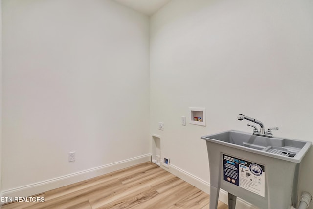 clothes washing area featuring hookup for an electric dryer, washer hookup, and light hardwood / wood-style floors