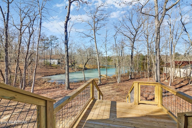 wooden terrace featuring a water view