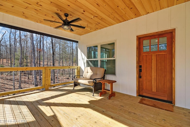 wooden deck featuring ceiling fan