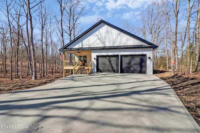 view of side of property featuring a garage and covered porch