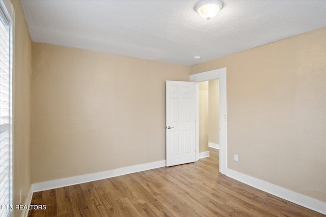 1231 Jefferson Ave, Maryville, TN 37804 - unfurnished room featuring a textured ceiling, wood finished floors, and baseboards