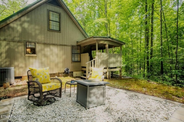 exterior space with central air condition unit and a fire pit