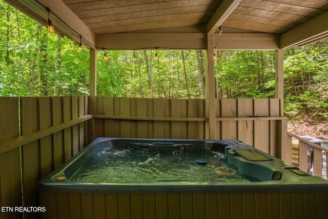 exterior space with a jacuzzi, lofted ceiling, and wooden ceiling