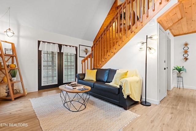 living room featuring light wood-type flooring and vaulted ceiling