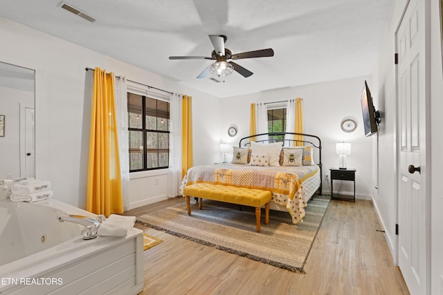 bedroom featuring hardwood / wood-style floors and ceiling fan