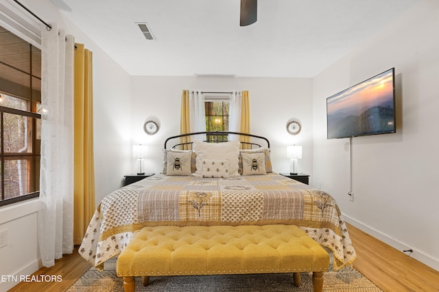 bedroom with hardwood / wood-style floors and ceiling fan