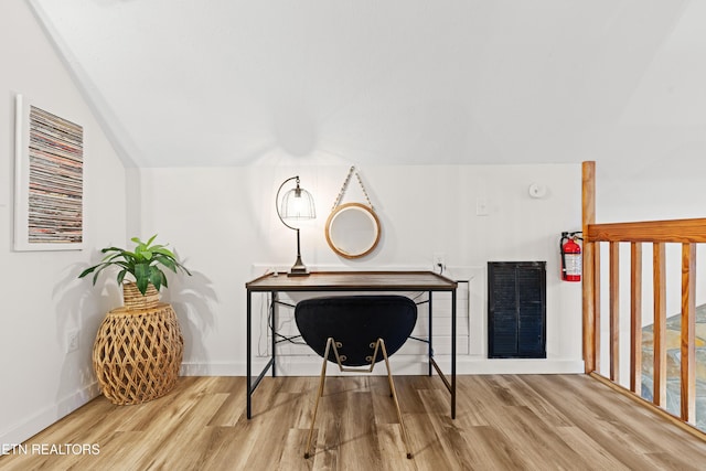 interior space with lofted ceiling and hardwood / wood-style floors