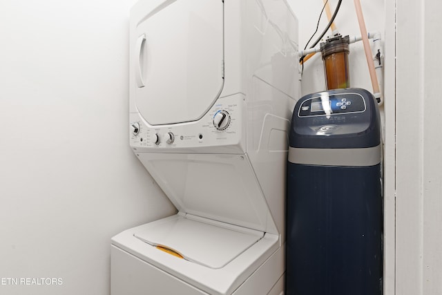 clothes washing area with stacked washer and dryer