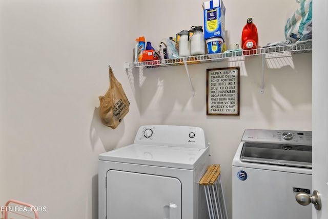 washroom featuring washer and clothes dryer