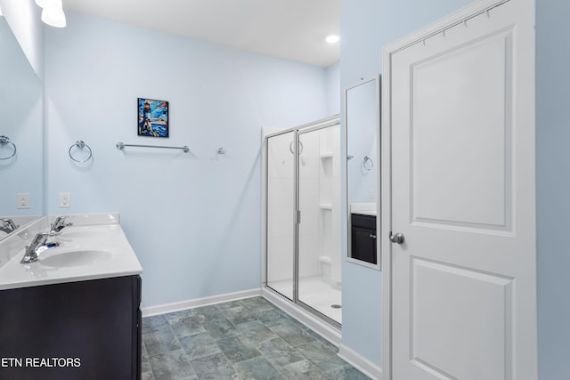 bathroom with an enclosed shower and vanity