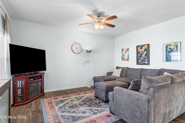 living room with dark hardwood / wood-style floors and ceiling fan