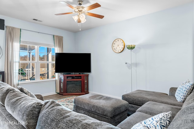 living room featuring ceiling fan and wood-type flooring