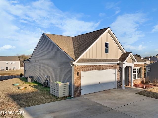 exterior space featuring a garage and central AC