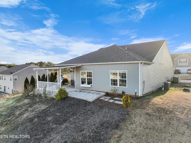 rear view of property with central AC unit, covered porch, and a patio area