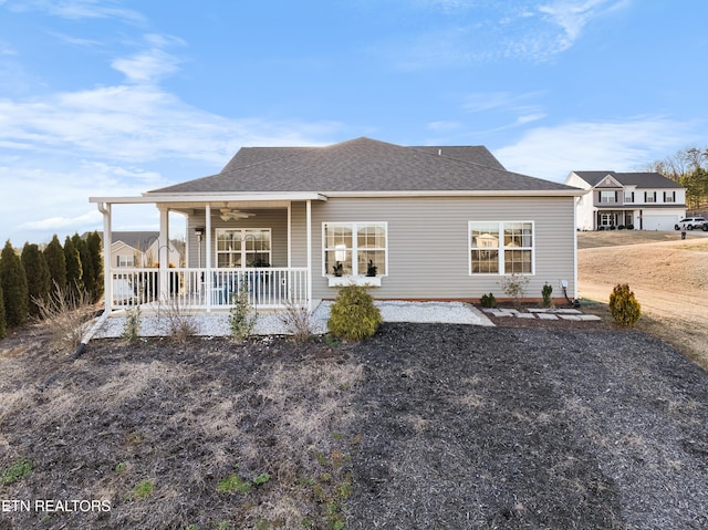 rear view of property featuring covered porch