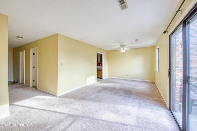 carpeted spare room with ceiling fan