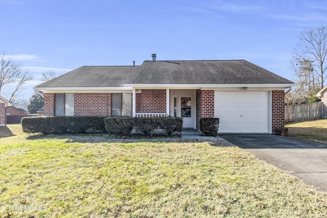 ranch-style house with a garage and a front lawn