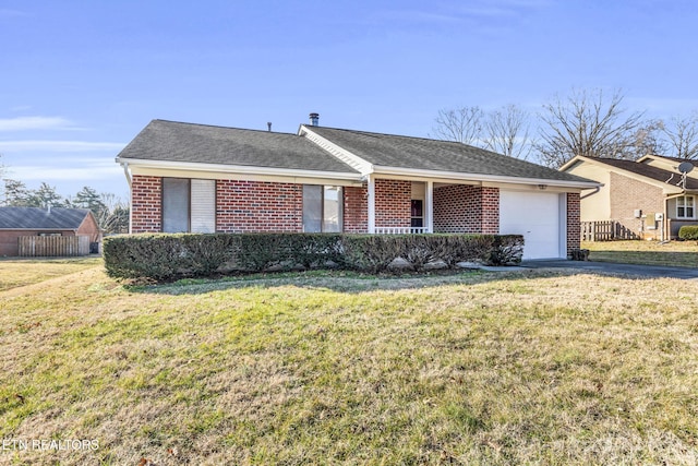 ranch-style house with a garage and a front lawn