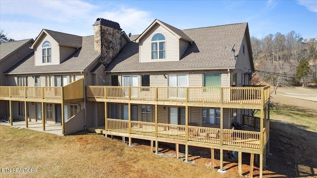 rear view of property featuring a patio and a balcony