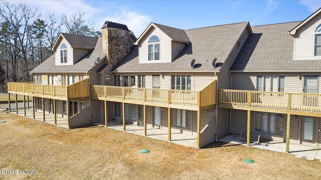 rear view of property with a balcony and a patio area