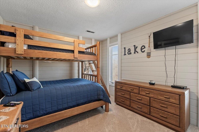 carpeted bedroom with a textured ceiling